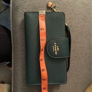 Wallet/wristlet never used. Comes with charm.